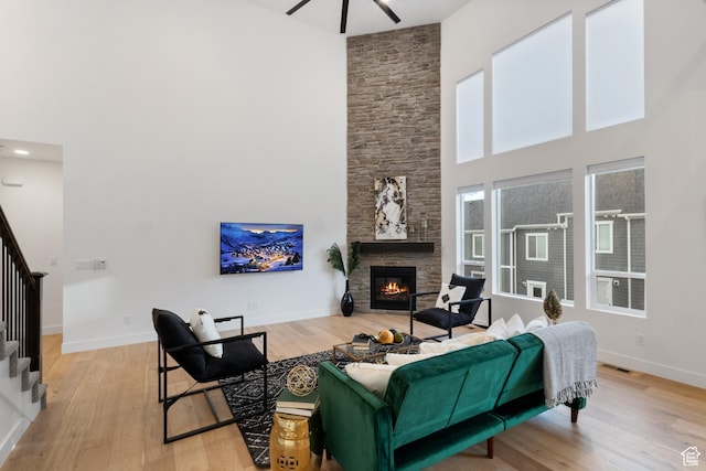 3973 N 900 W, Lehi, UT 84043 - living area with a high ceiling, stairway, wood finished floors, a fireplace, and ceiling fan