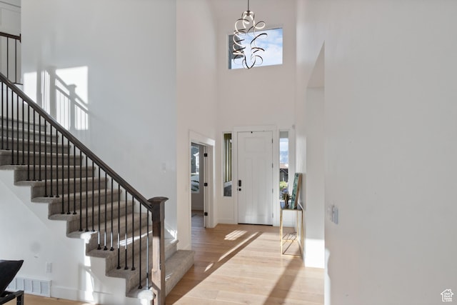 3973 N 900 W, Lehi, UT 84043 - foyer entrance featuring a towering ceiling, stairway, light wood-type flooring, and a chandelier