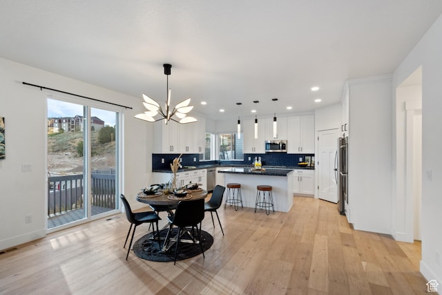 3973 N 900 W, Lehi, UT 84043 - dining space with light wood finished floors, a chandelier, and recessed lighting