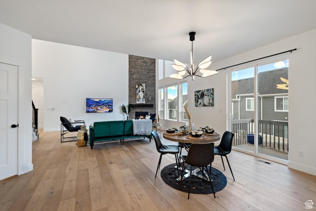 3973 N 900 W, Lehi, UT 84043 - dining room featuring a chandelier, a fireplace, and light wood-style flooring