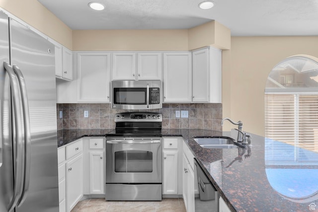 3548 E Wasatch Hills Ln S, Cottonwood Heights, UT 84121 - kitchen with appliances with stainless steel finishes, white cabinets, dark stone counters, decorative backsplash, and recessed lighting