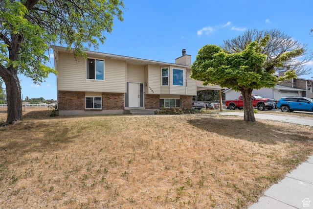 4323 W Benview Dr, West Valley City, UT 84120 - raised ranch featuring brick siding and a chimney