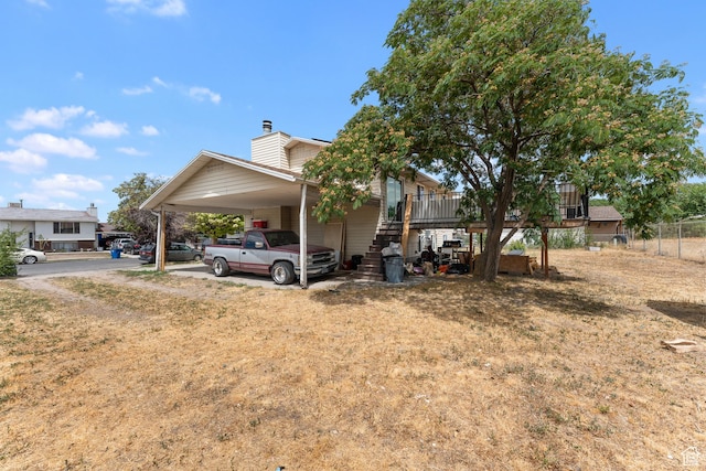 4323 W Benview Dr, West Valley City, UT 84120 - view of home's exterior with a chimney, an attached carport, and driveway