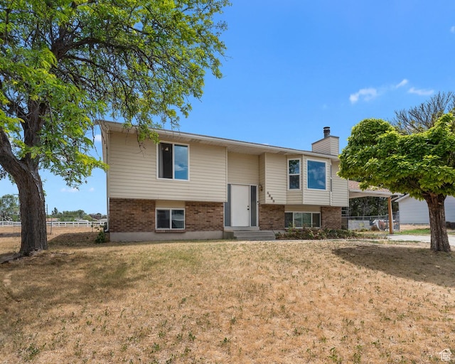4323 W Benview Dr, West Valley City, UT 84120 - raised ranch featuring brick siding and a chimney