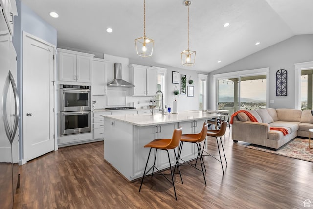 7603 S Scenic Maple Dr S, West Jordan, UT 84081 - kitchen with wall chimney range hood, stainless steel appliances, lofted ceiling, open floor plan, and dark wood-style floors