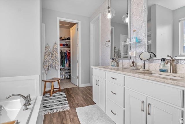 7603 S Scenic Maple Dr S, West Jordan, UT 84081 - full bath featuring double vanity, wood finished floors, a spacious closet, and a bathtub