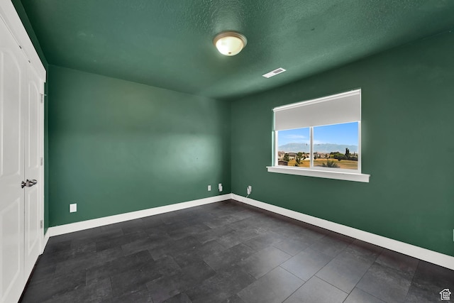 9602 N Blue Sky Dr, Eagle Mountain, UT 84005 - spare room featuring baseboards and a textured ceiling