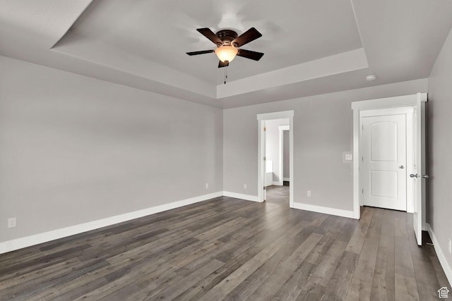 9602 N Blue Sky Dr, Eagle Mountain, UT 84005 - empty room featuring a raised ceiling, ceiling fan, and dark wood-style floors