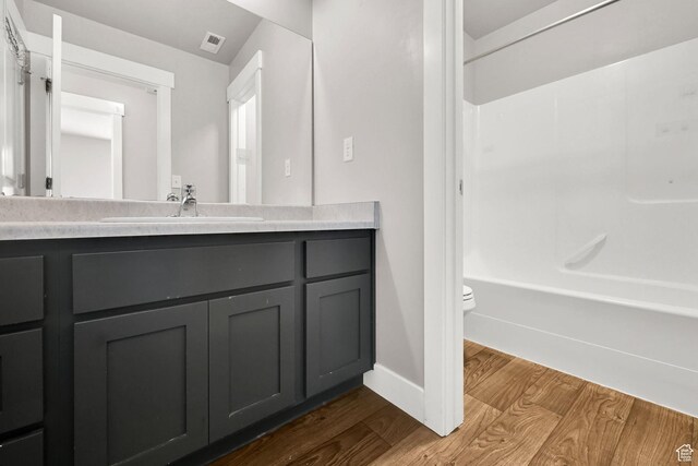 9602 N Blue Sky Dr, Eagle Mountain, UT 84005 - full bathroom featuring wood finished floors, vanity, and  shower combination