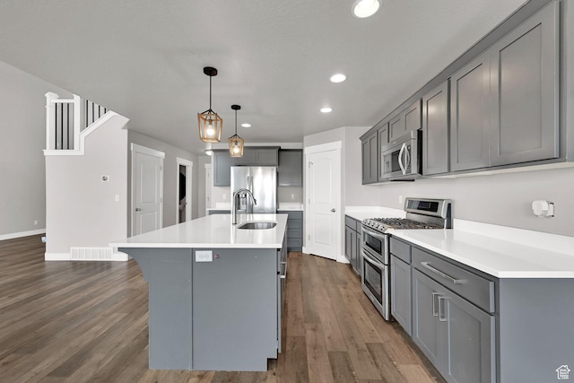 9602 N Blue Sky Dr, Eagle Mountain, UT 84005 - kitchen with appliances with stainless steel finishes, gray cabinetry, recessed lighting, dark wood-style flooring, and light countertops