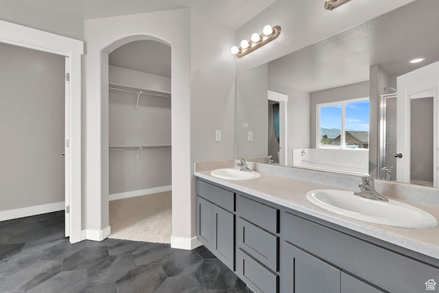 9602 N Blue Sky Dr, Eagle Mountain, UT 84005 - bathroom featuring double vanity, a spacious closet, a stall shower, and a bathtub