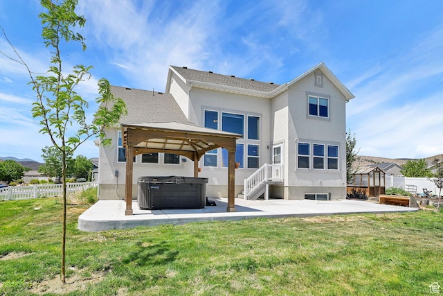 9602 N Blue Sky Dr, Eagle Mountain, UT 84005 - rear view of property featuring a hot tub, a patio area, a gazebo, a fenced backyard, and stucco siding