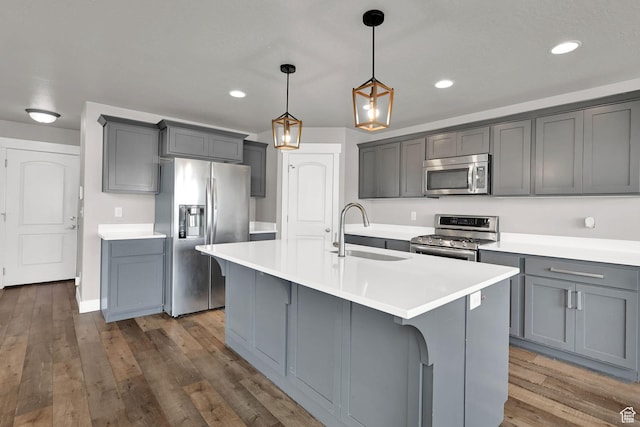 9602 N Blue Sky Dr, Eagle Mountain, UT 84005 - kitchen with stainless steel appliances, gray cabinetry, recessed lighting, wood finished floors, and light countertops