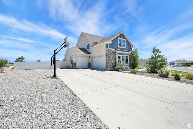 9602 N Blue Sky Dr, Eagle Mountain, UT 84005 - view of front of home with board and batten siding, stone siding, driveway, and a gate