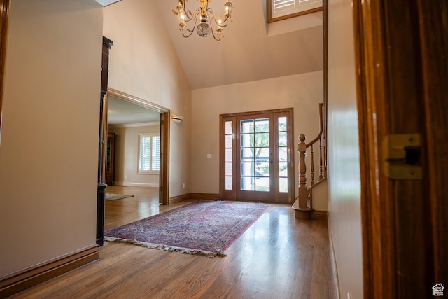 13251 S 1162 E, Draper, UT 84020 - foyer with high vaulted ceiling, a chandelier, wood finished floors, and stairway