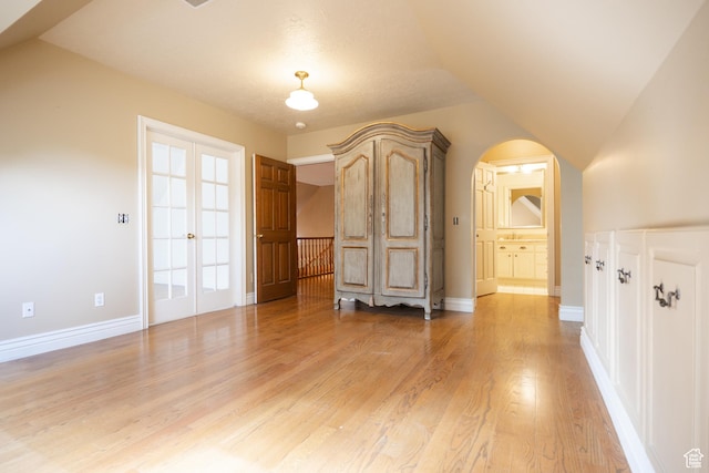 13251 S 1162 E, Draper, UT 84020 - unfurnished bedroom featuring arched walkways, light wood-style floors, and french doors