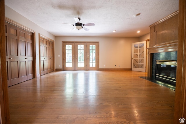 13251 S 1162 E, Draper, UT 84020 - unfurnished living room with a textured ceiling, light wood-type flooring, ceiling fan, a fireplace, and recessed lighting