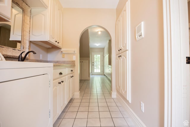 13251 S 1162 E, Draper, UT 84020 - hallway with washer / dryer, light tile patterned floors, and arched walkways