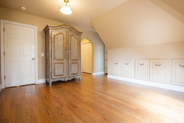 13251 S 1162 E, Draper, UT 84020 - bonus room featuring light wood-style flooring, vaulted ceiling, and arched walkways