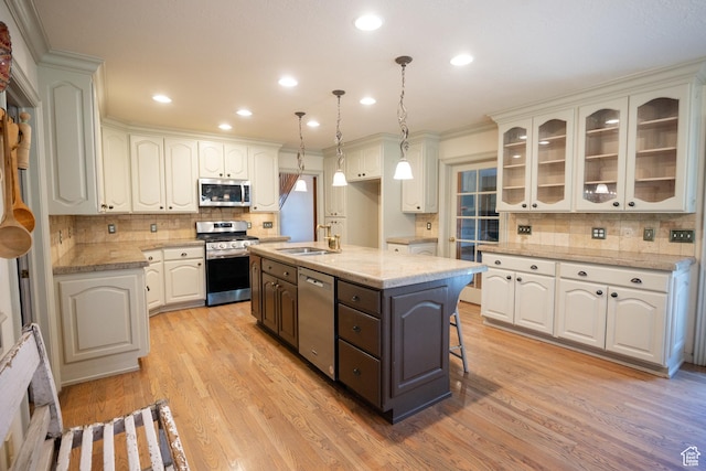 13251 S 1162 E, Draper, UT 84020 - kitchen with appliances with stainless steel finishes, decorative backsplash, white cabinetry, a kitchen island with sink, and recessed lighting