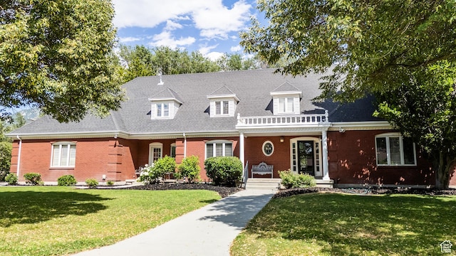 13251 S 1162 E, Draper, UT 84020 - cape cod house with brick siding, covered porch, a front yard, and a shingled roof