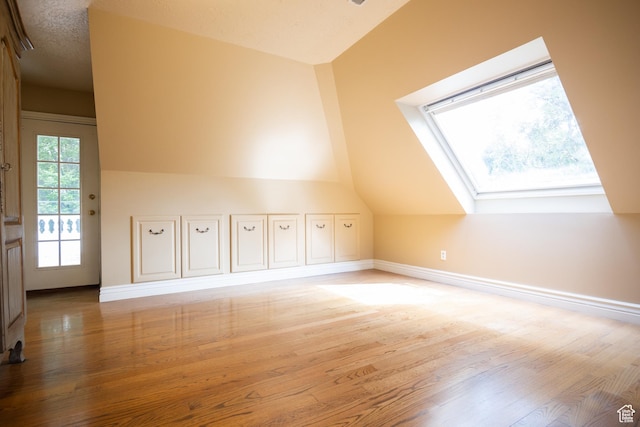 13251 S 1162 E, Draper, UT 84020 - additional living space featuring a skylight, vaulted ceiling, and wood finished floors