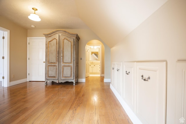 13251 S 1162 E, Draper, UT 84020 - corridor with light wood-style floors, arched walkways, and lofted ceiling