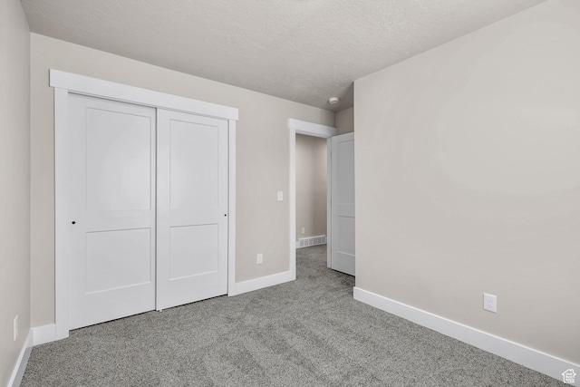 155 N 1600 W, West Point, UT 84015 - unfurnished bedroom with carpet flooring, a closet, and a textured ceiling