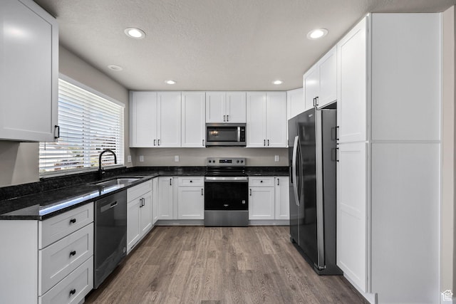 155 N 1600 W, West Point, UT 84015 - kitchen featuring stainless steel appliances, wood finished floors, white cabinetry, recessed lighting, and dark stone countertops