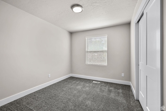 155 N 1600 W, West Point, UT 84015 - unfurnished bedroom with dark colored carpet, a textured ceiling, and a closet