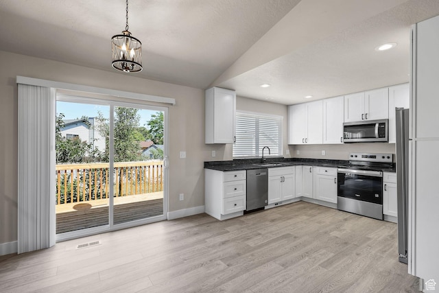 155 N 1600 W, West Point, UT 84015 - kitchen with appliances with stainless steel finishes, light wood-style floors, plenty of natural light, lofted ceiling, and recessed lighting