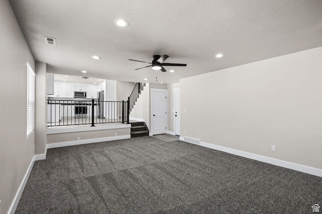 155 N 1600 W, West Point, UT 84015 - spare room with ceiling fan, a textured ceiling, dark carpet, recessed lighting, and stairway