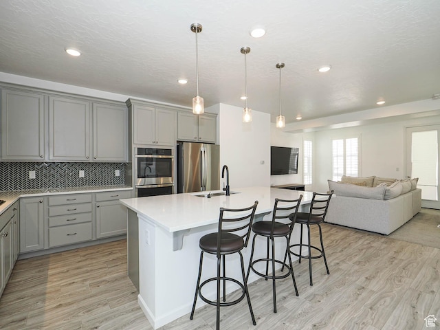 609 E 460 S, American Fork, UT 84003 - kitchen with gray cabinetry, stainless steel appliances, light wood-type flooring, open floor plan, and recessed lighting