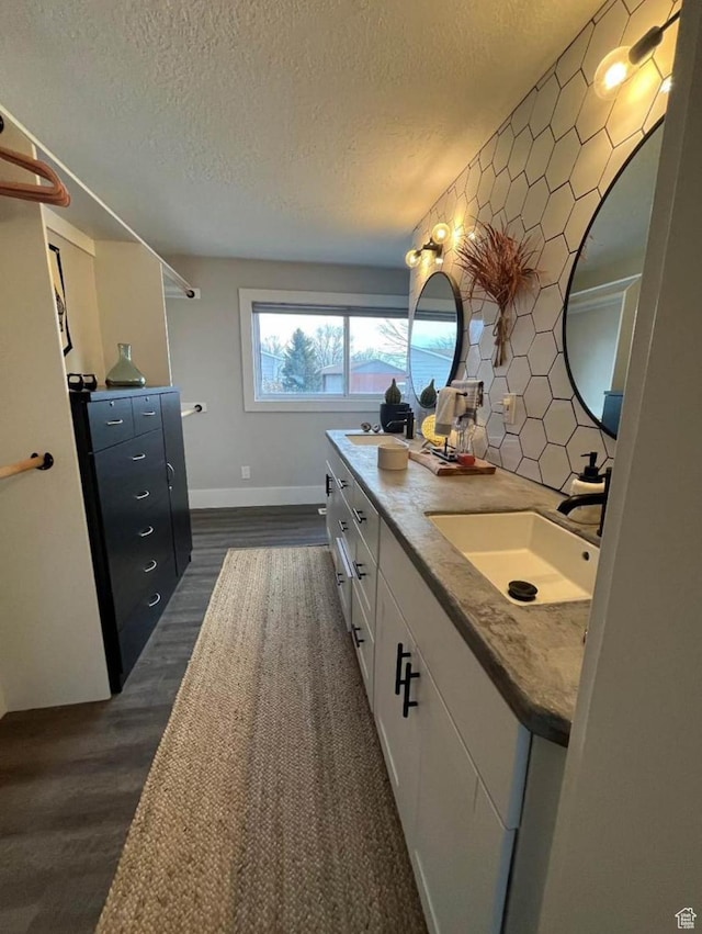 1101 W 1870 N, Lehi, UT 84043 - bathroom with double vanity, a textured ceiling, wood finished floors, and tasteful backsplash