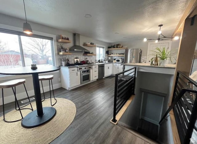 1101 W 1870 N, Lehi, UT 84043 - kitchen with wall chimney range hood, open shelves, appliances with stainless steel finishes, white cabinets, and tasteful backsplash