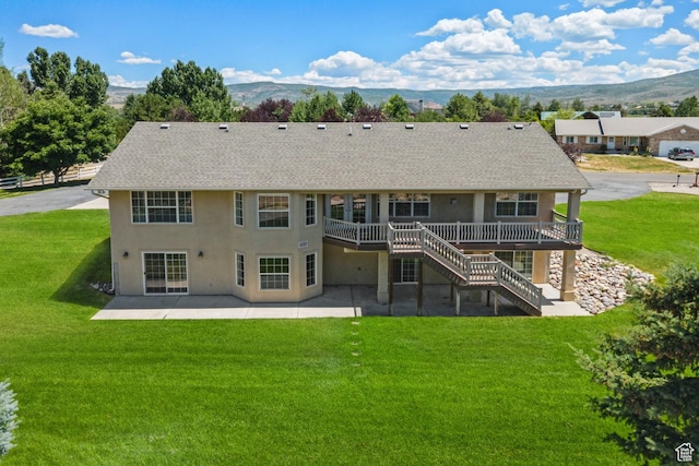 1516 S Lost Colt Dr, Heber City, UT 84032 - back of property featuring a patio area, roof with shingles, a deck with mountain view, and a lawn