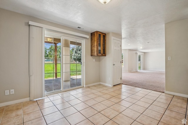 1516 S Lost Colt Dr, Heber City, UT 84032 - unfurnished room featuring a textured ceiling, light tile patterned flooring, and light colored carpet