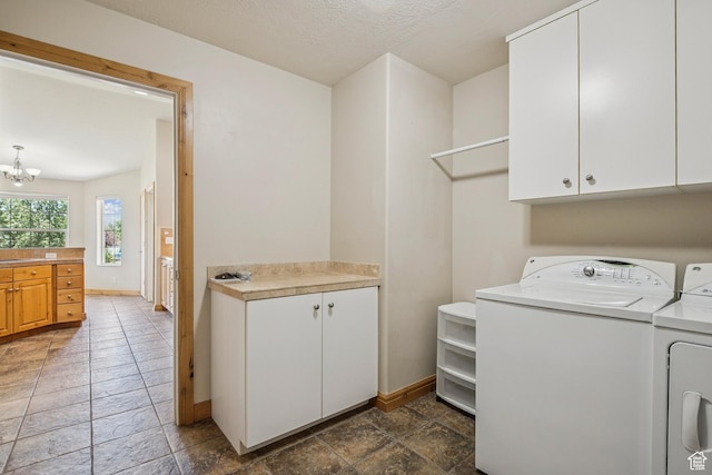 1516 S Lost Colt Dr, Heber City, UT 84032 - laundry room with washer and clothes dryer, cabinet space, a chandelier, and stone tile flooring