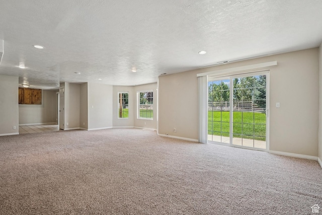 1516 S Lost Colt Dr, Heber City, UT 84032 - unfurnished living room with healthy amount of natural light, carpet, a textured ceiling, and recessed lighting