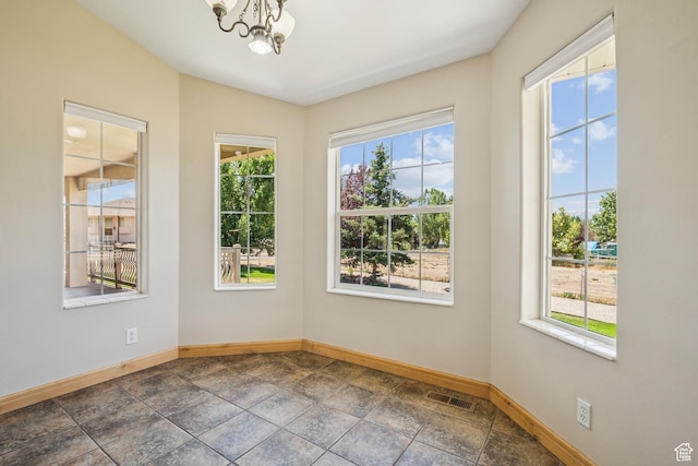 1516 S Lost Colt Dr, Heber City, UT 84032 - spare room featuring a chandelier and dark stone finish floors