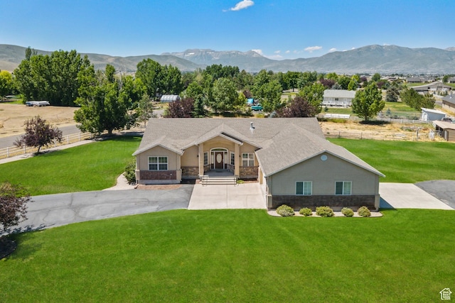 1516 S Lost Colt Dr, Heber City, UT 84032 - view of front of house featuring stone siding, a mountain view, stucco siding, and a front lawn