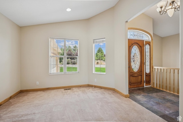 1516 S Lost Colt Dr, Heber City, UT 84032 - carpeted foyer featuring healthy amount of natural light, a chandelier, high vaulted ceiling, and stone finish flooring