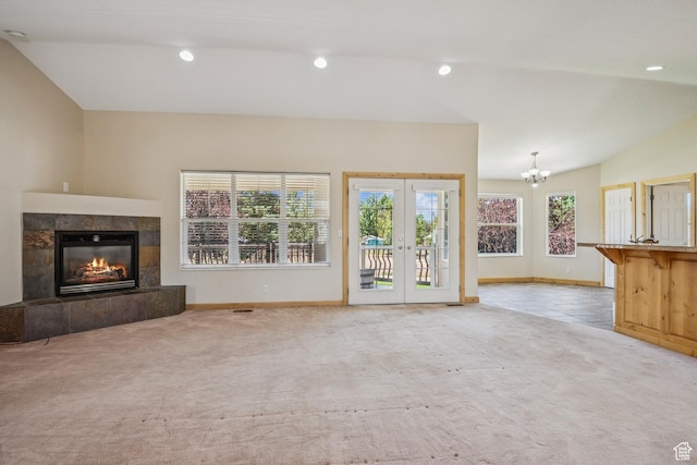 1516 S Lost Colt Dr, Heber City, UT 84032 - unfurnished living room with carpet floors, a chandelier, a tiled fireplace, french doors, and recessed lighting
