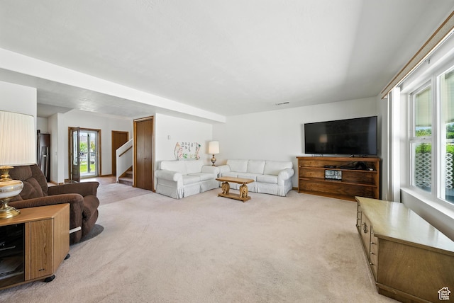 3036 S Dovetail Dr, West Valley City, UT 84128 - living room with light colored carpet and stairs