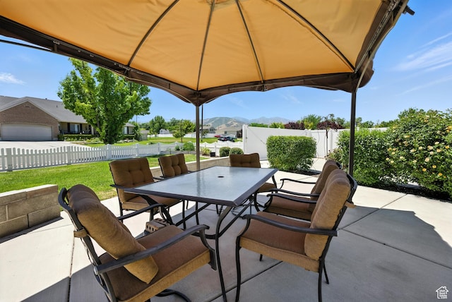 3036 S Dovetail Dr, West Valley City, UT 84128 - fenced backyard with outdoor dining area, a patio, and a mountain view