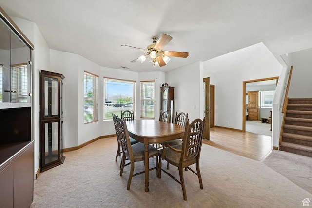 3036 S Dovetail Dr, West Valley City, UT 84128 - dining area with light carpet, stairs, and a ceiling fan