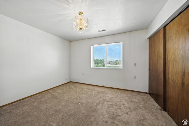 3036 S Dovetail Dr, West Valley City, UT 84128 - unfurnished bedroom featuring light colored carpet, a chandelier, and a closet