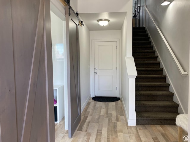 5137 W Stockfield Ln, Herriman, UT 84096 - staircase with a barn door and wood finished floors