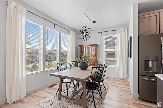 5137 W Stockfield Ln, Herriman, UT 84096 - dining area with a chandelier and light wood-style floors