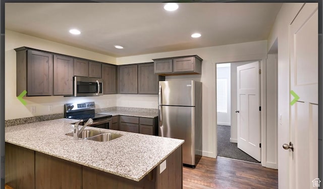 796 E 500 S, American Fork, UT 84003 - kitchen featuring appliances with stainless steel finishes, a peninsula, dark wood-style flooring, dark brown cabinetry, and recessed lighting